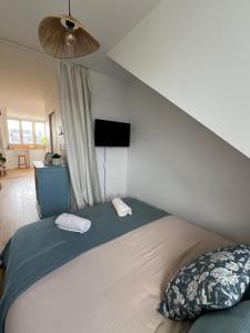 a bedroom with a bed with two pillows on it at Cozy studio in Cancale in Cancale