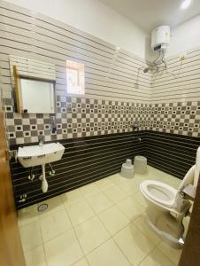 a bathroom with a sink and a toilet at AVON Homes in Jodhpur