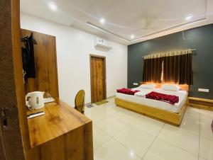 a hotel room with a bed and a desk at AVON Homes in Jodhpur