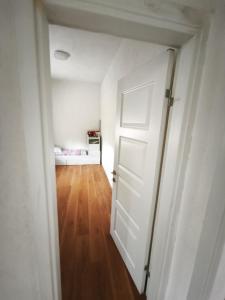 an empty room with a door and a bedroom at Spacious City Center Apartment for 6 - Steps from Hilton & Republic Square in Podgorica +1 photo