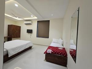 a bedroom with a bed and a tv on the wall at AVON Homes in Jodhpur +4 photos