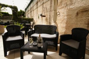 a patio with chairs and a table with wine glasses at TERRA MIA in Città Giardino