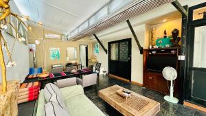 a living room with a couch and a table at Montra Resort in Lamai