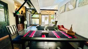 a living room with a table and a couch at Montra Resort in Lamai