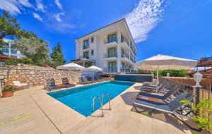 a swimming pool in front of a building at Kas Athena Hotel in Kaş