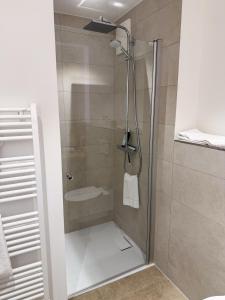 a shower with a glass door in a bathroom at Boardinghouse in Büsum +41 photos