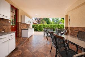 a kitchen and dining room with chairs and a table at Marina Panzio in Siófok
