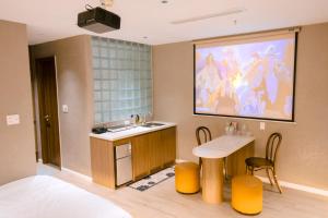 a hotel room with a sink and a table and a painting at UMEE Homestay in Thôn Trường Giang +47 photos