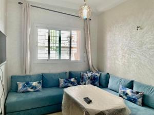 a blue couch in a living room with a table at luxury apartment in fez in Fez