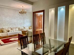 a dining table and chairs in a living room at luxury apartment in fez in Fez
