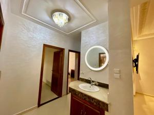 a bathroom with a sink and a mirror at luxury apartment in fez in Fez
