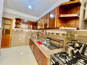 a kitchen with wooden cabinets and a stove top oven at luxury apartment in fez in Fez +7 photos