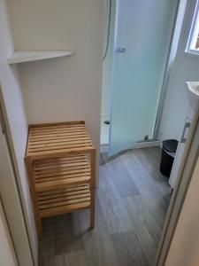 a small wooden table in a room with a closet at Ocean Lodge Messanges in Messanges +11 photos