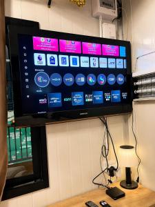 a flat screen tv hanging on a wall at NearBKKHomestayAirport in Bang Phli