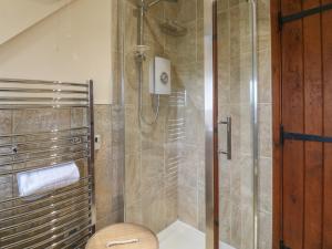 a bathroom with a shower with a toilet and a glass door at Barclay Cottage in Ashford +13 photos