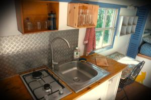 a kitchen counter with a sink and a stove at Roulotte nature in Salernes