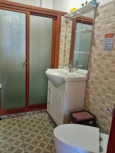 a bathroom with a sink and a toilet and a mirror at Carpenters homestay in Sagada +35 photos