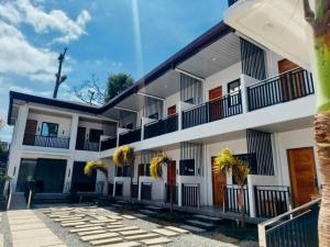 a large white building with balconies on it at The Annwin Hotel - Sablayan in Sablayan