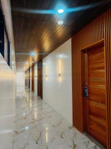 an empty hallway with a door and a marble floor at The Annwin Hotel - Sablayan in Sablayan