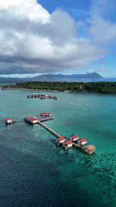 an aerial view of a dock in the water at Coco Seaweed Resort in Semporna