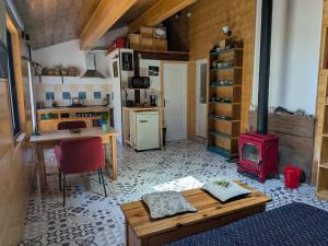 a kitchen with a table and a stove in a room at LoFt Les Castilléres in Condat-sur-Trincou