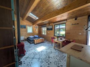 a bedroom with a bed and a table in a room at LoFt Les Castilléres in Condat-sur-Trincou