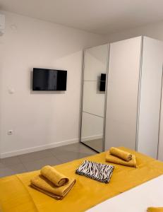 a room with a table with two towels on it at Apartments Paradise Hvar in Hvar
