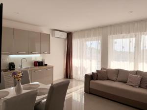 a living room with a couch and a table at Apartments Paradise Hvar in Hvar