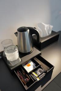a tray with a tea kettle on top of a table at Auberge du Bon Vivant in Argelès-sur-Mer