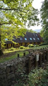 a barn with a building with a fence in front of it at ELYSIA Nature & Spa in Boersch
