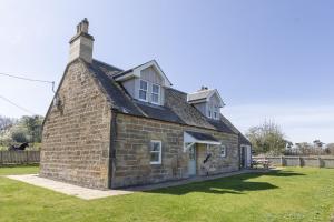 an old brick building with a chimney on top at Coldwells Farmhouse in Dalkeith