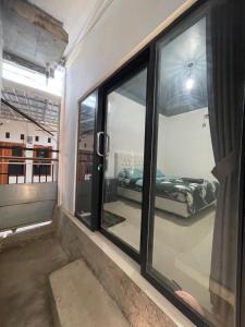 a room with a window with a bed in it at AFWA Surf and Stay in Selong Belanak