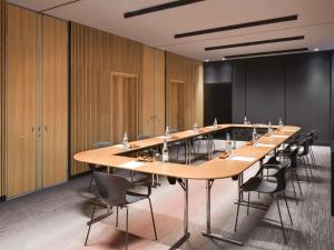 a conference room with a long table and chairs at Novotel Kinshasa La Gombe in Kinshasa +115 photos
