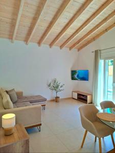 a living room with a couch and a table at Villa Eleni Apartment no3 in Agios Gordios