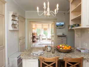 a kitchen with a bowl of fruit on a counter at Golden Villas Luxury Garden Villa - Kraków in Węgrzce