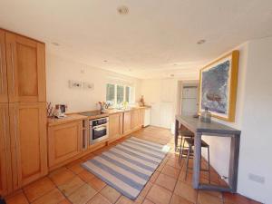 a kitchen with a table and a counter top at 2 bed cottage, in the Wicklow Mountains in Tinahely