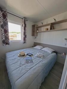 a bedroom with a large bed in a room at Camping Le Chassezac in Sampzon