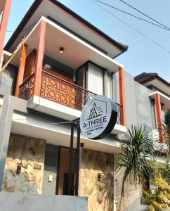 a house with a sign in front of it at A-Three Guest House in Malang +3 photos