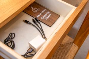 a drawer with a plug and a cord in it at べっどぷらす in Wakkanai