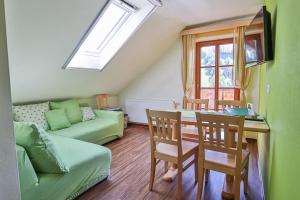 a living room with a table and a couch at Ferienhof Pfaffenlehen in Maria Neustift