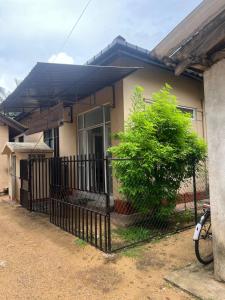 a house with a black fence in front of it at Floreen villa in Moratuwa