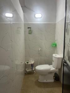 a bathroom with a toilet and a glass shower at Floreen villa in Moratuwa +5 photos