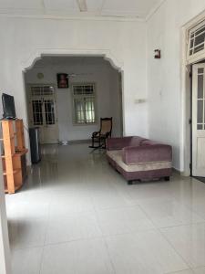 a living room with a bed and a chair at Floreen villa in Moratuwa