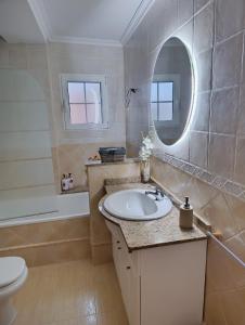 a bathroom with a sink and a mirror and a toilet at Casa Rural La Tejeria in Villora +51 photos