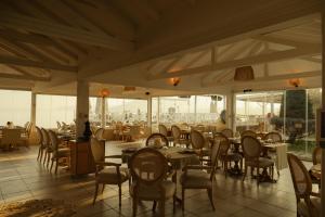 a dining room with tables and chairs and windows at Lale Boutique Hotel in Sapanca