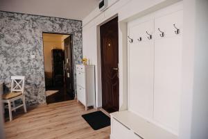 a room with a hallway with a door to a kitchen at The Home in Gheorgheni