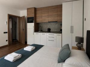 a bedroom with a bed with two towels on it at IQ Apartments in Prešov