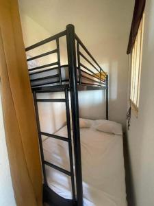 a bunk bed in a room with a ladder at Studio cabine, vue mer, piscine in Saint-Cyprien-Plage +6 photos
