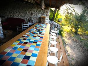 a long wooden table with chairs around it at Roulotte nature in Salernes +14 photos
