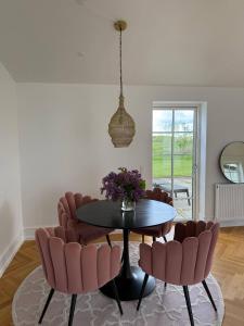 a dining room with a table and chairs at Estate in calm nature in Sorø